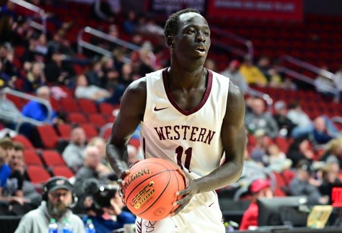 Hull Western Christian's Uchan Harberts looks for a teammate to pass the ball to against Iowa City Regina during a Class 2A state tournament quarterfinal game at Wells Fargo Arena in Des Moines on Monday. (Photo by Ryan Timmerman)